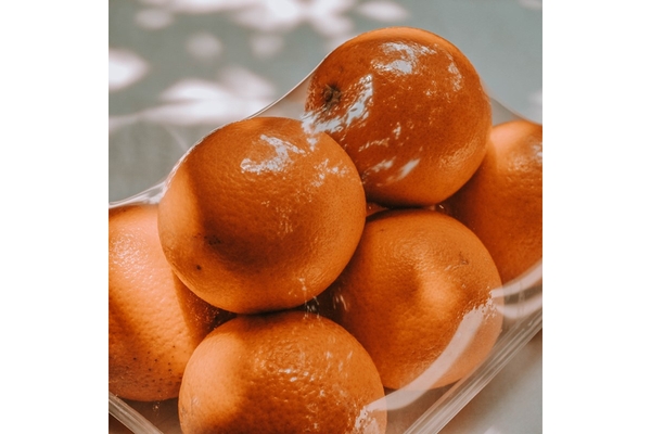 Image Oranges wrapped in plastic.